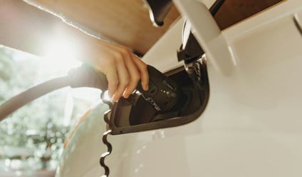 a person charging an electric car