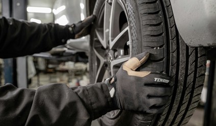 a man working on a tire in a garage