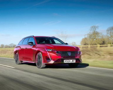 Peugeot e-308 SW lease car in red driving on the road