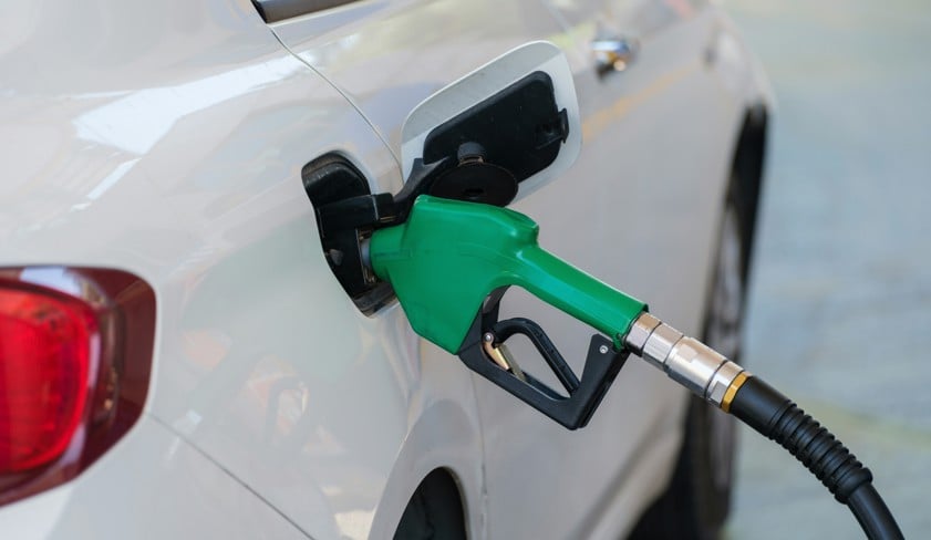 a white car with a green gas pump