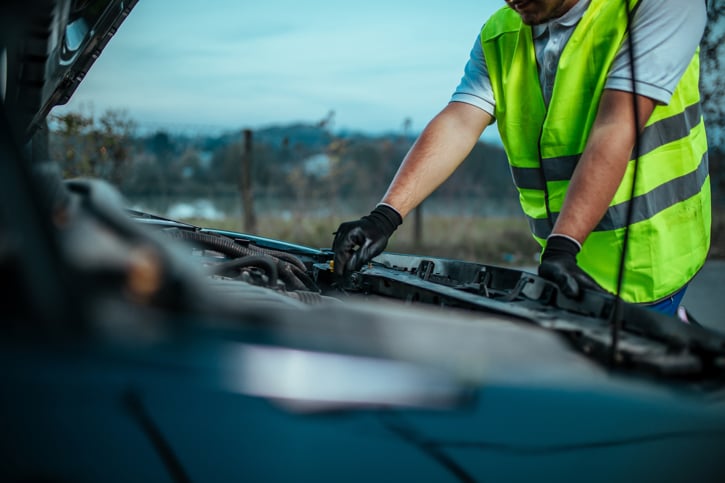 Mechanic taking care of broken van