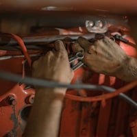 person fixing car
