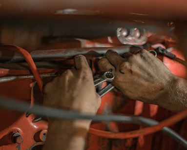person fixing car