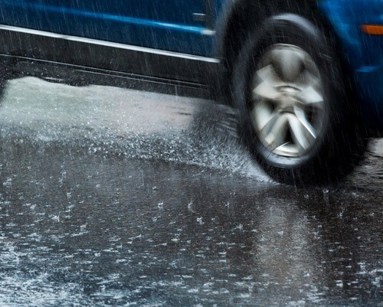 close up of car tyre driving in rain
