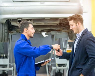 car mechanic handing keys to driver