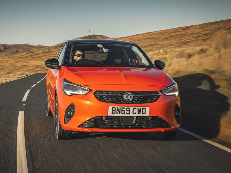 Vauxhall Corsa-e on a road crossing rolling hills