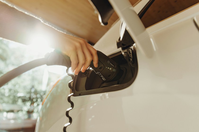 a person charging an electric car