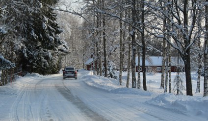 black car on road covered with snow during daytime