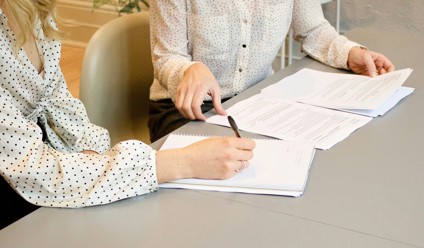 woman signing documents