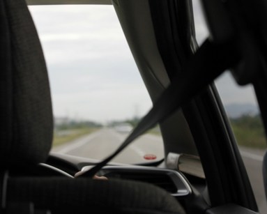 Person driving car with seatbelt on