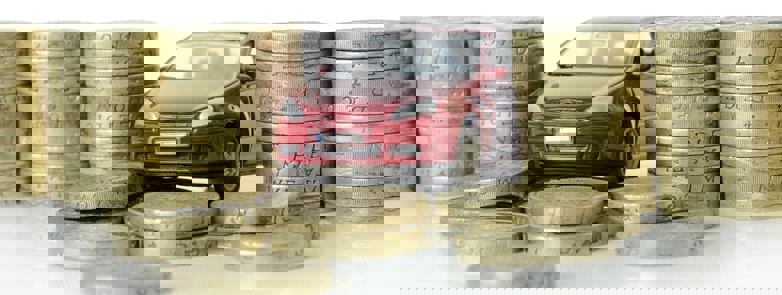 Toy car surrounded by coins
