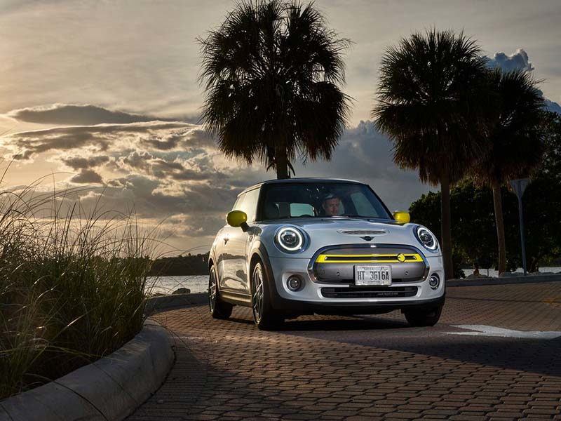 Mini Electric Hatchback in a tropical area at sunset