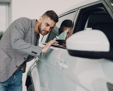 Man inspecting car at a dealership