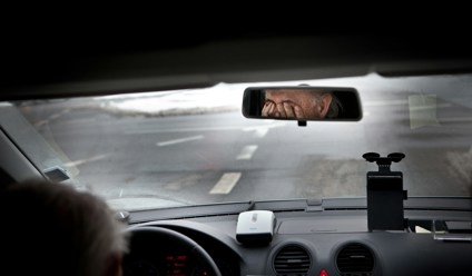 Tired taxidriver rubbing his eyes driver fatigue road