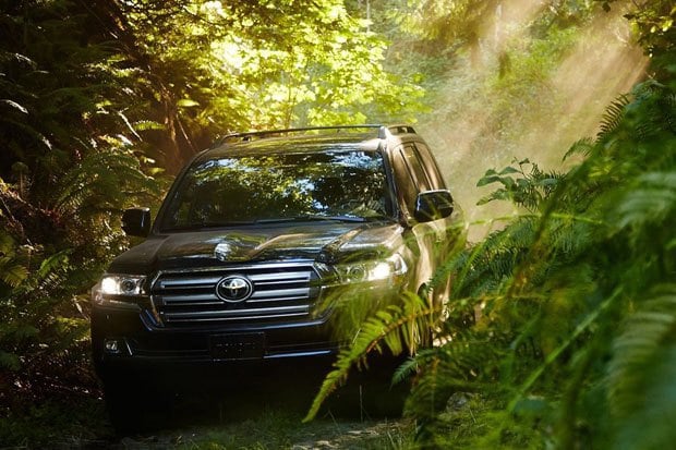 The front of a grey Toyota Land Cruiser off-roading 