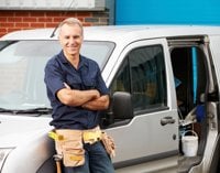 van driver leaning on van