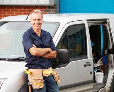 van driver leaning on van
