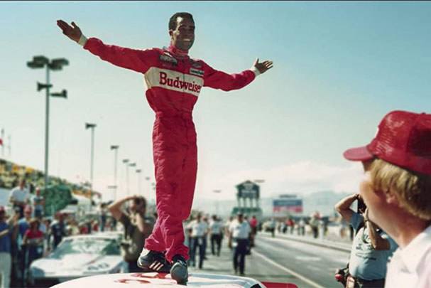 A promotional image for the documentary "Uppity: The Willy T. Ribbs Story," featuring Willy T. Ribbs in a racing suit and helmet.