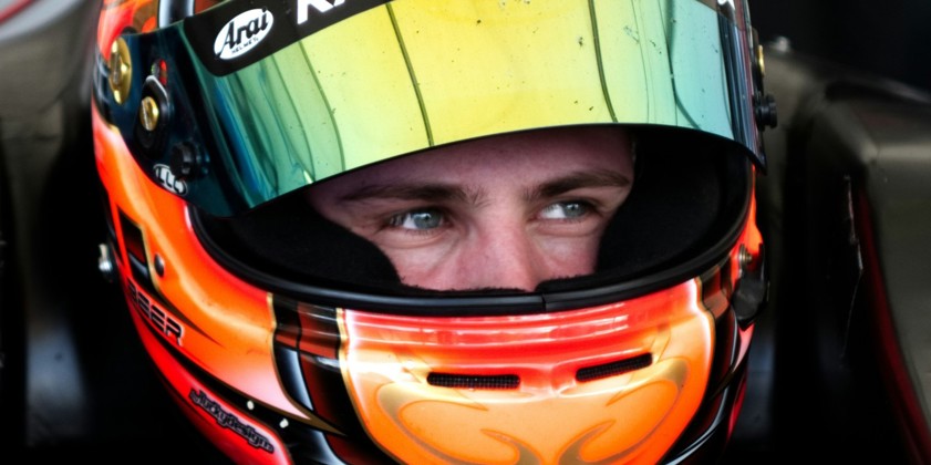 man riding sports car wearing helmet