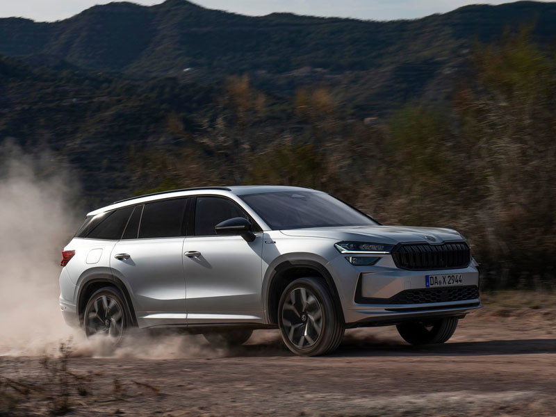 Skoda Kodiaq in silver driving on a country track with dust coming out from under the tyres