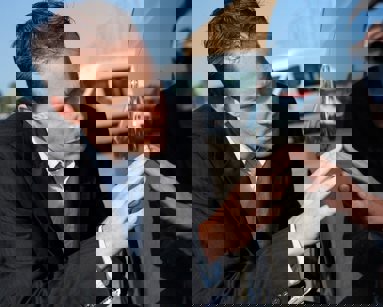 man inspecting car for damage