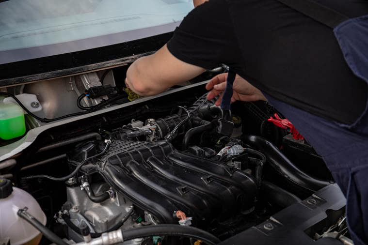 Mechanic inspecting car engine
