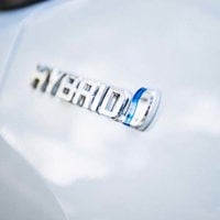 close up of hybrid badge on car