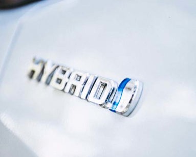 close up of hybrid badge on car