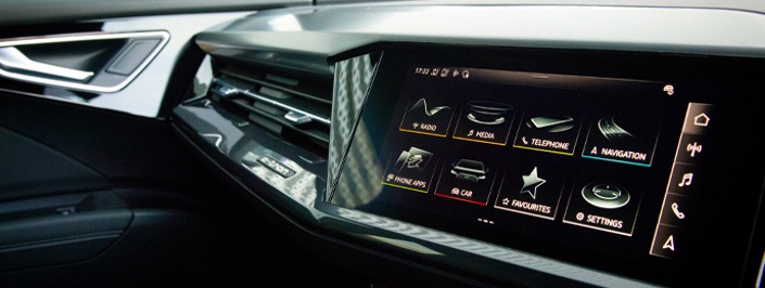 black and grey car dashboard showing infotainment screen