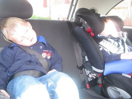 Children asleep in the back of a car
