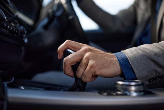 close up of driver holding automatic gear stick