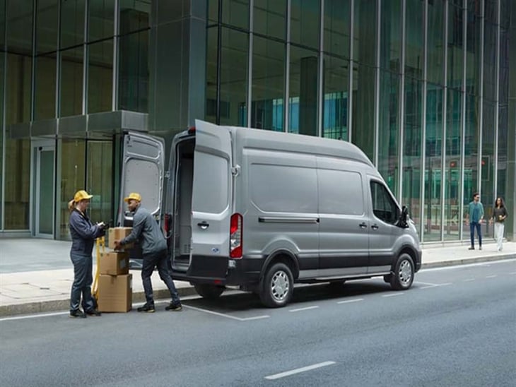 workmen loading boxes into e-transit