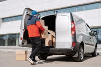 Man loading boxes into silver van