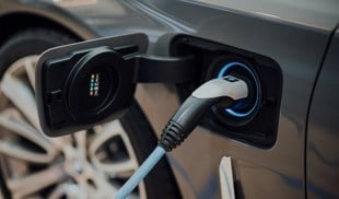 electric vehicle charging cable plugged into car