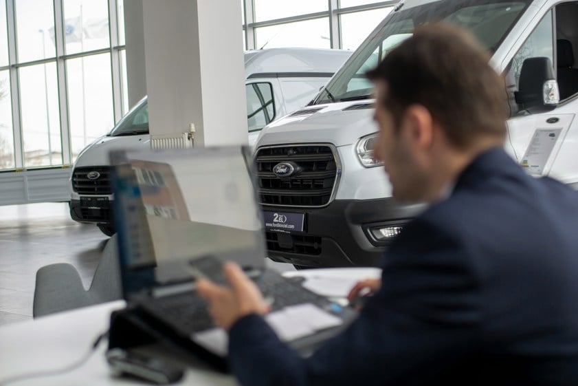 a man sitting in front of a laptop computer
