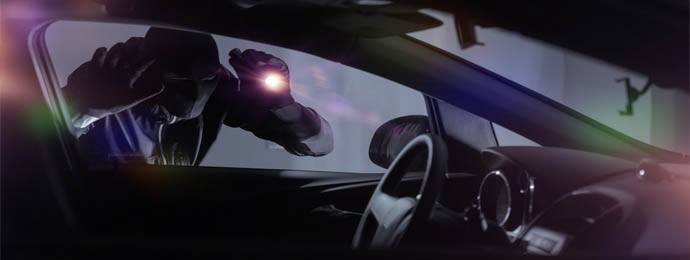 thief looking into van with a torch