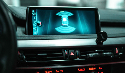 Close-up of a car dashboard with a digital screen and controls