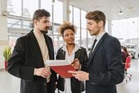 Dealer consulting a couple about a car lease