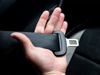 Hand holding seatbelt