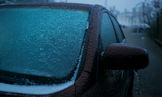 a car covered in ice on a snowy day