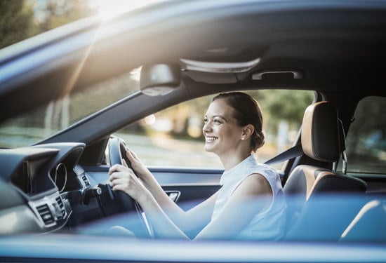 Businesswoman driving a  coupe car