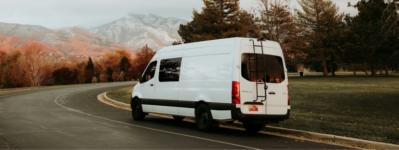 a white van driving down a curvy road