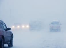 road covered in snow with cars driving