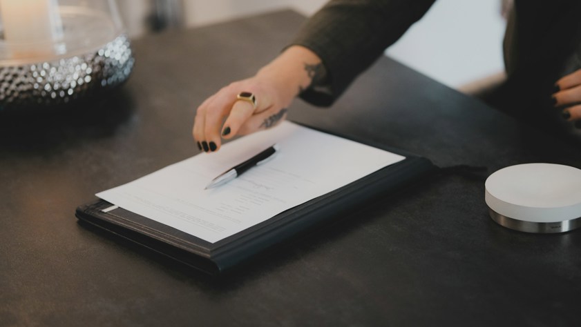 A person writing on a piece of paper