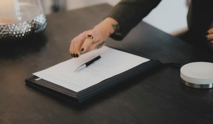 A person writing on a piece of paper