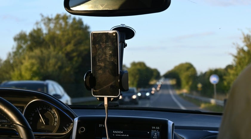 a car dashboard with a cell phone attached to it