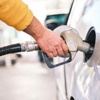 man filling car with fuel