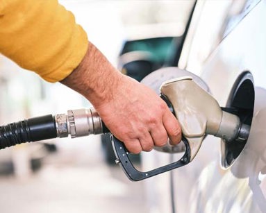 man filling car with fuel