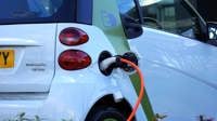 Close-up of an electric car being charged, highlighting eco-friendly transportation