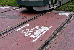 Tram driving over tramlines on road